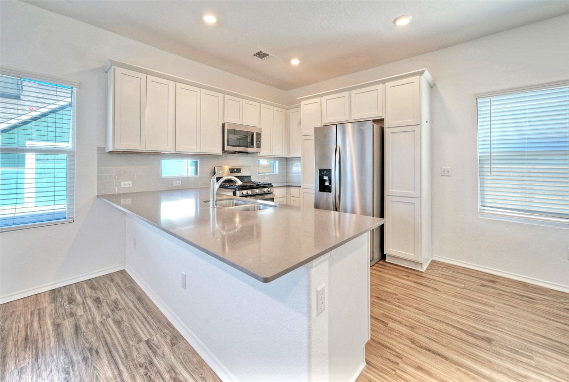 201 Rioja Kyle, TX 78640 - Photo 6 of 21 a kitchen with stainless steel appliances granite countertop a sink refrigerator and microwave