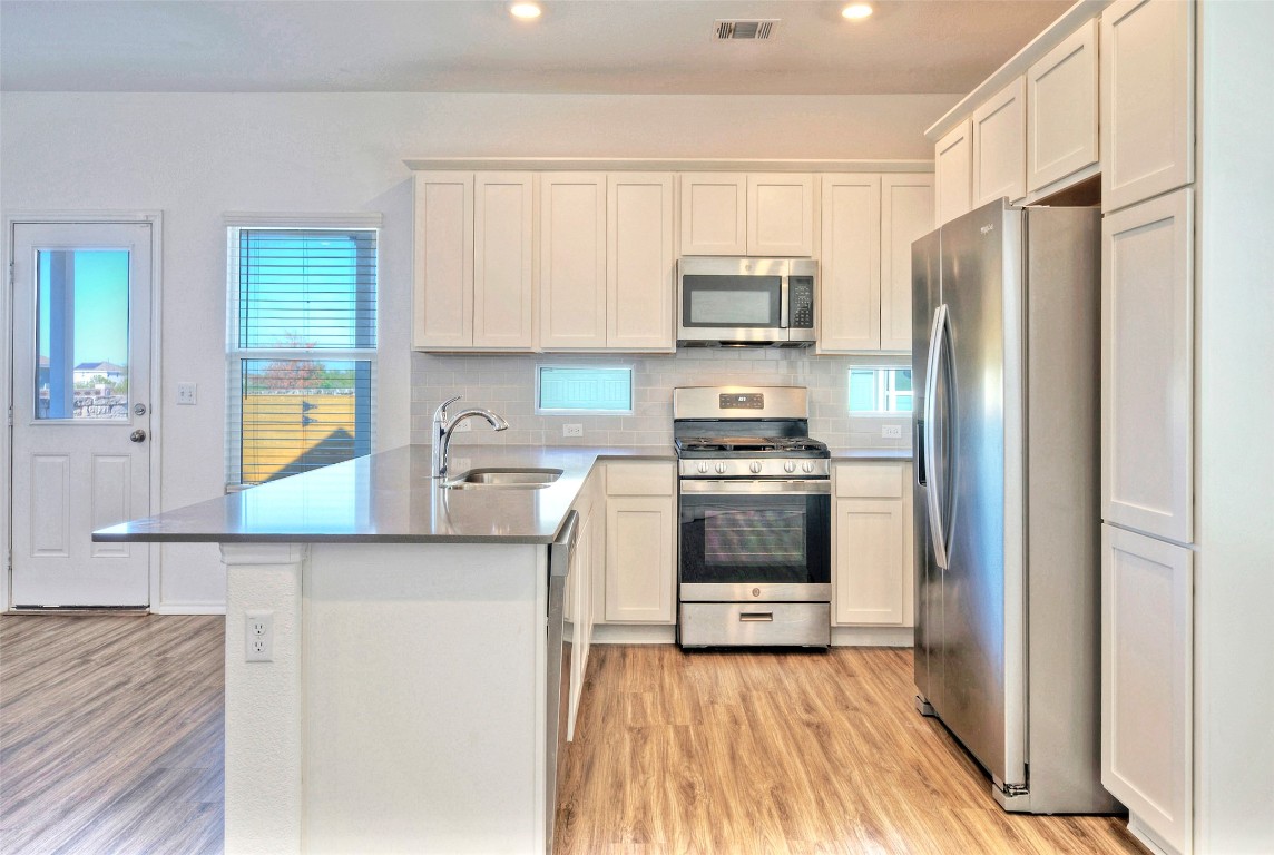 201 Rioja Kyle, TX 78640 - Photo 7 of 21 a kitchen with stainless steel appliances a refrigerator sink and microwave