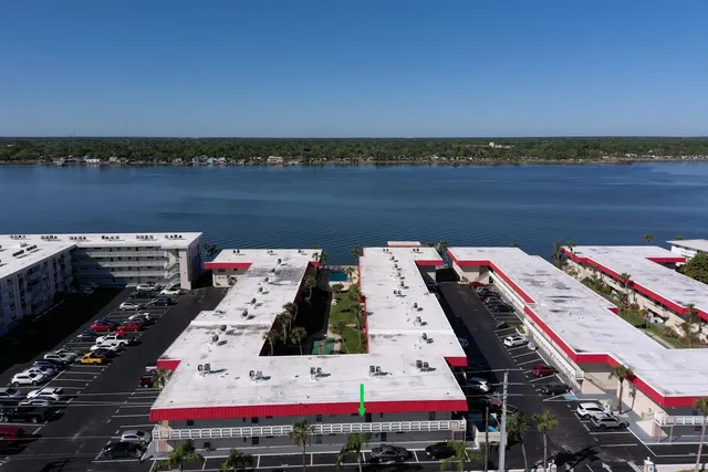 a view of a balcony with wooden floor and outdoor seating