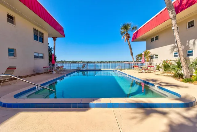 a view of a swimming pool with two chairs