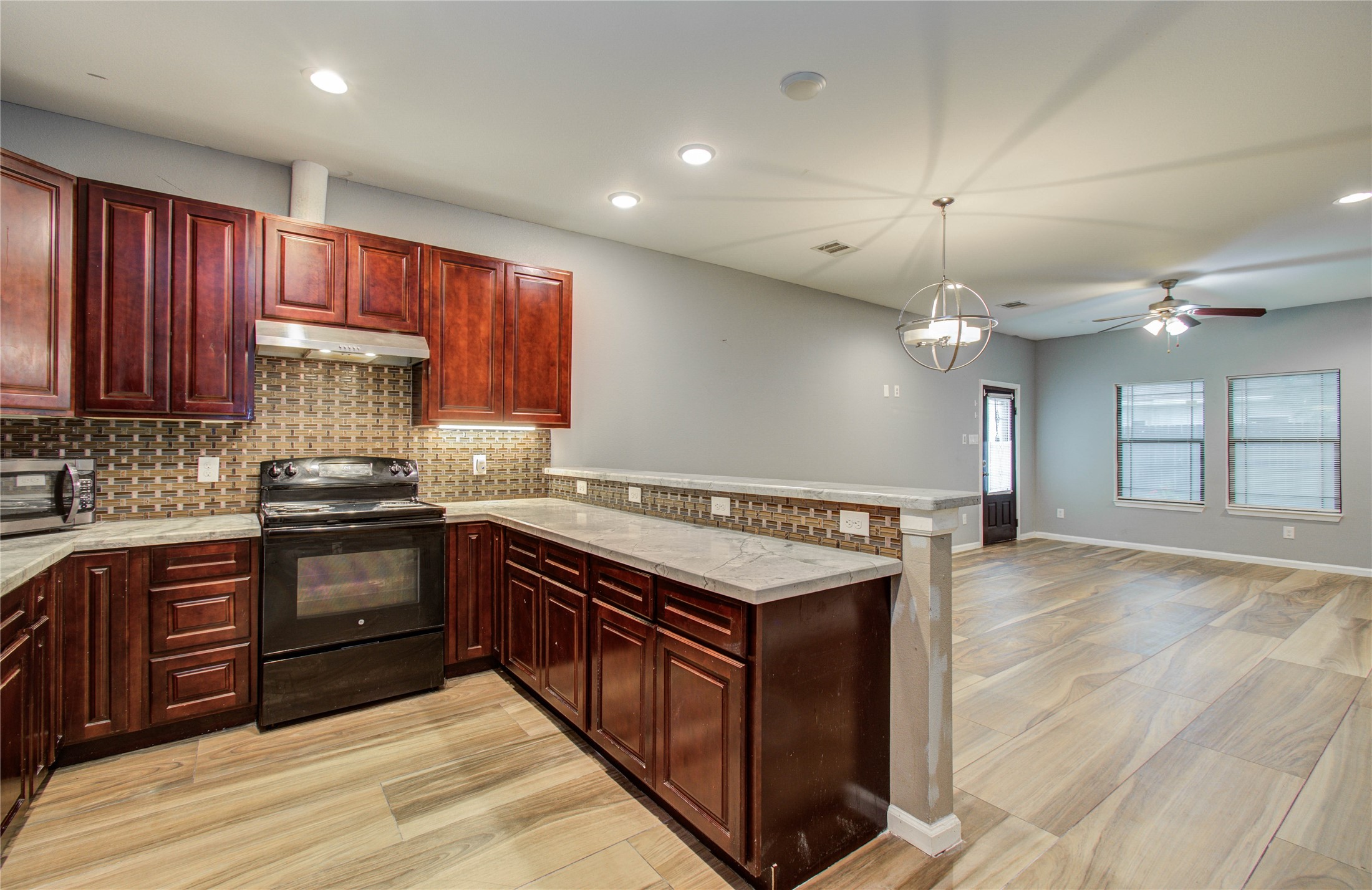 8040 Howton Street, Unit 12 Houston, TX 77028 - Photo 11 of 35 a kitchen with stainless steel appliances granite countertop a stove a sink dishwasher and a refrigerator