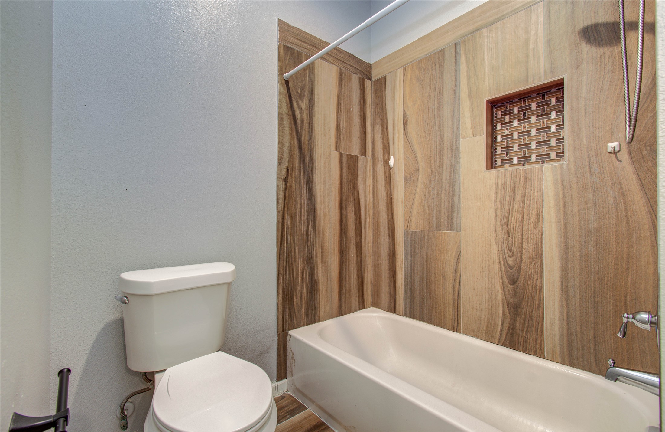 8040 Howton Street, Unit 12 Houston, TX 77028 - Photo 15 of 35 a white toilet sitting next to a shower curtain
