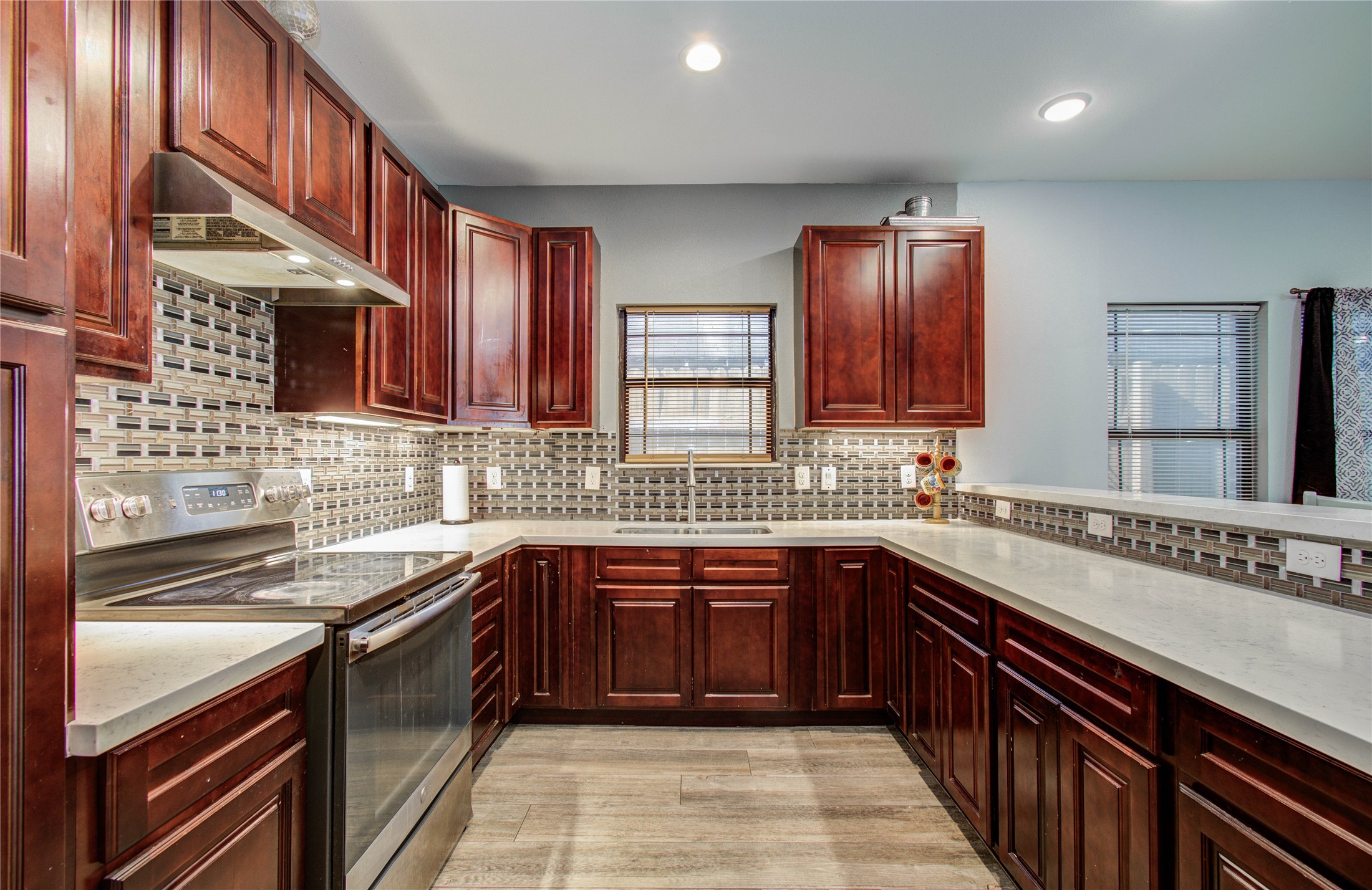 8040 Howton Street, Unit 12 Houston, TX 77028 - Photo 23 of 35 a kitchen with stainless steel appliances granite countertop a sink stove and cabinets
