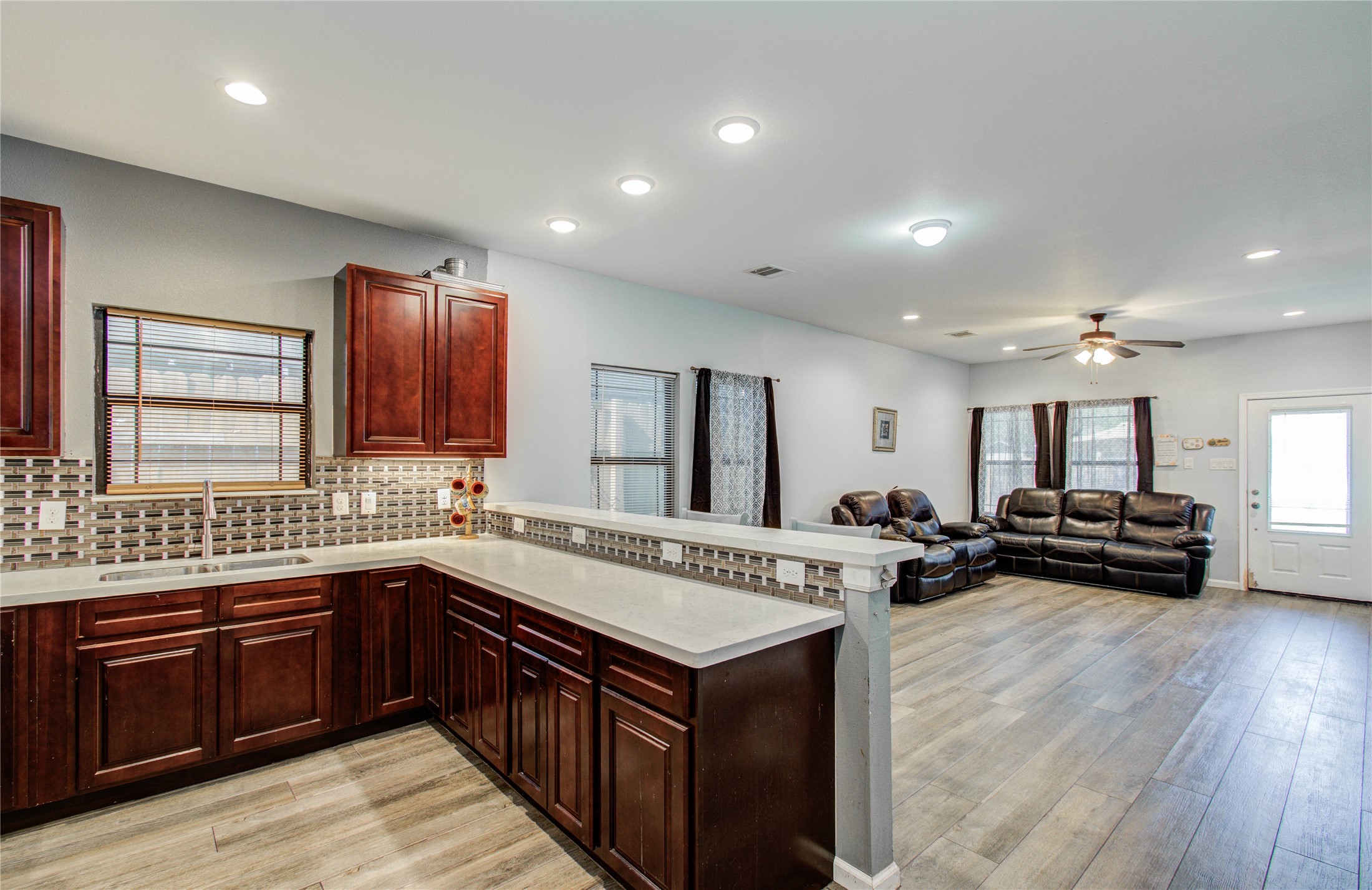 8040 Howton Street, Unit 12 Houston, TX 77028 - Photo 24 of 35 a kitchen with a stove a sink a refrigerator and wooden cabinets