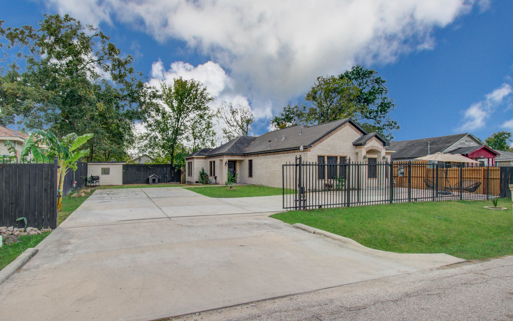 8040 Howton Street, Unit 12 Houston, TX 77028 - Photo 3 of 35 a view of house with garden and tall trees