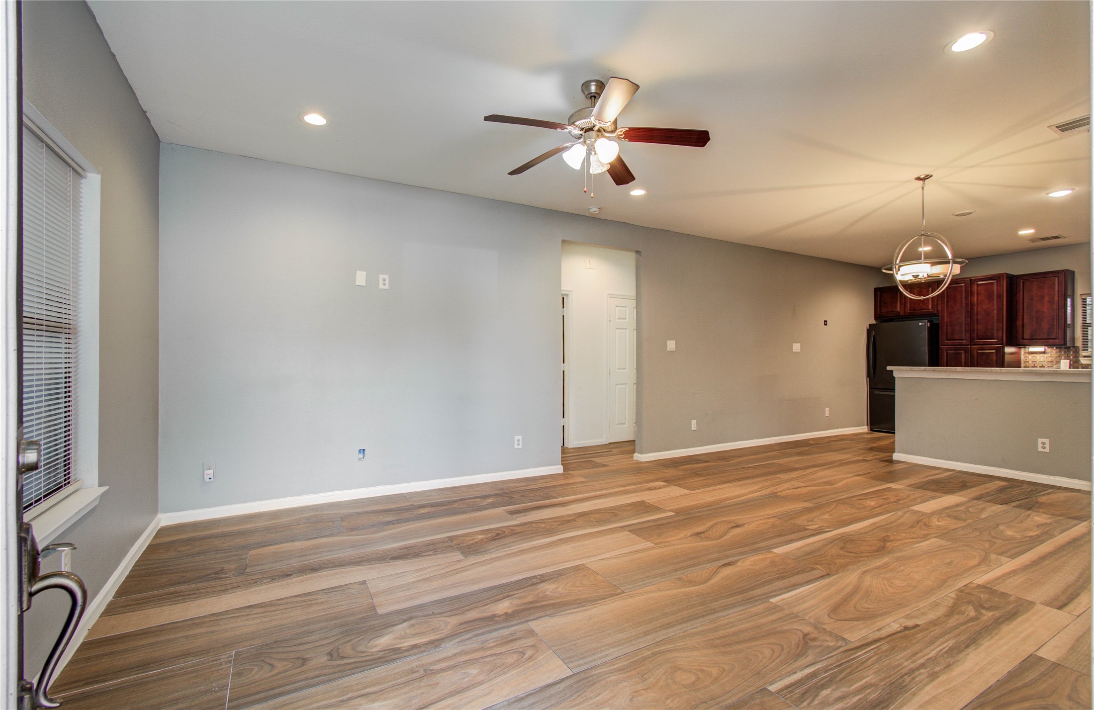 8040 Howton Street, Unit 12 Houston, TX 77028 - Photo 5 of 35 an empty room with wooden floor and natural light
