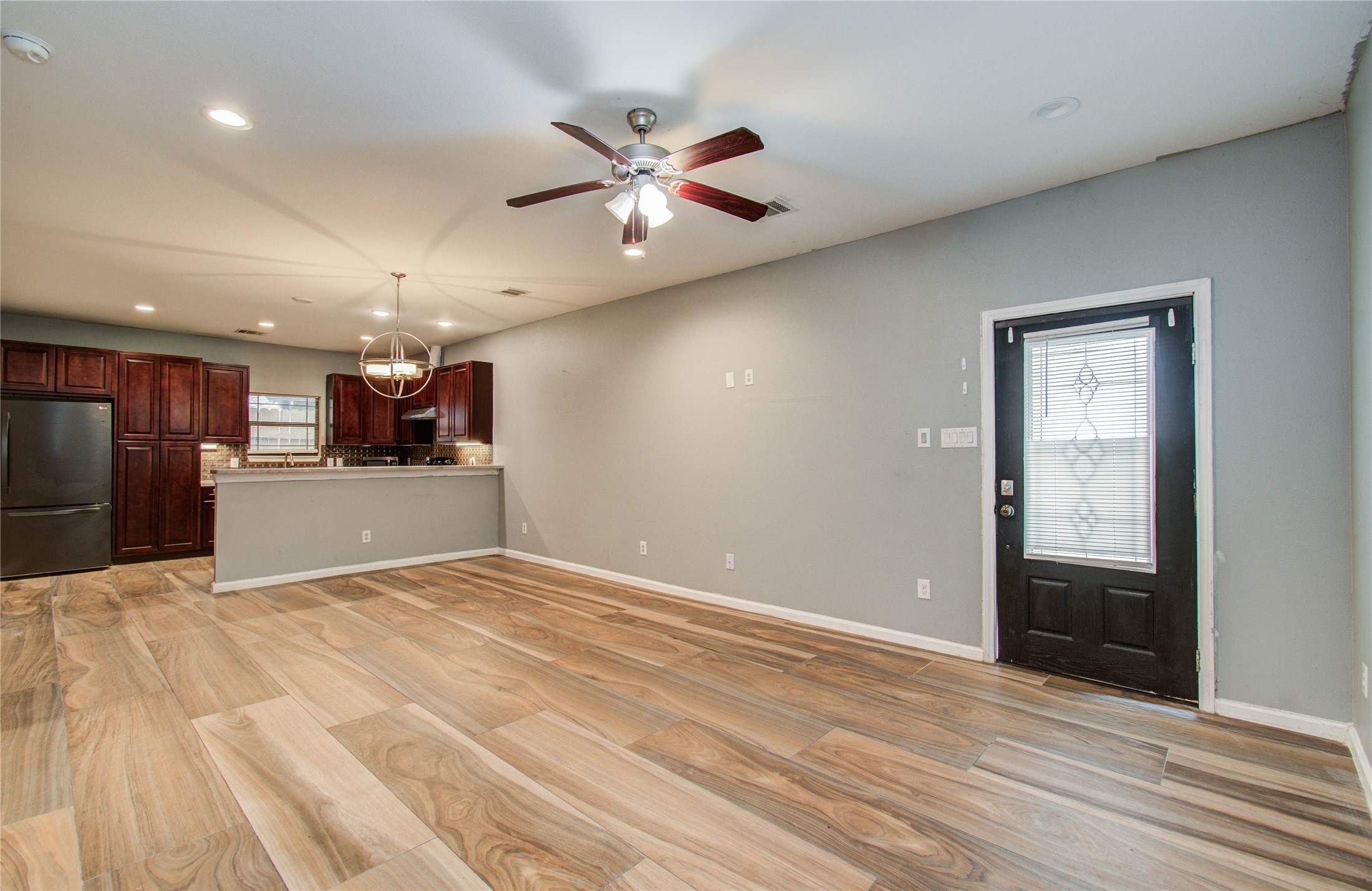 8040 Howton Street, Unit 12 Houston, TX 77028 - Photo 6 of 35 a view of a livingroom with a ceiling fan and wooden floor