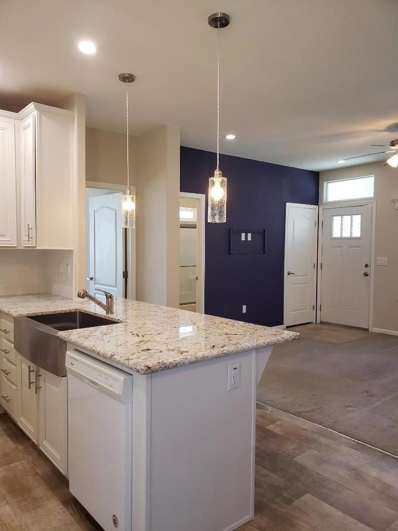 440 Moffett Boulevard, Unit 84 Mountain View, CA 94043 - Photo 16 of 38 a kitchen with a sink a stove a refrigerator and chandelier
