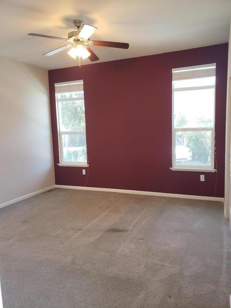 440 Moffett Boulevard, Unit 84 Mountain View, CA 94043 - Photo 20 of 38 an empty room with windows and fan
