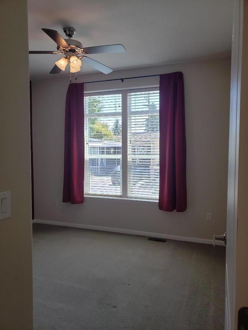 440 Moffett Boulevard, Unit 84 Mountain View, CA 94043 - Photo 25 of 38 a view of an empty room with window and chandelier fan