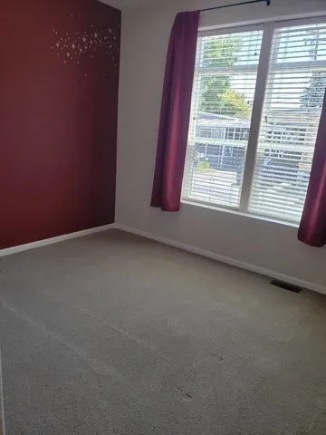 a white toilet sitting next to a bathroom