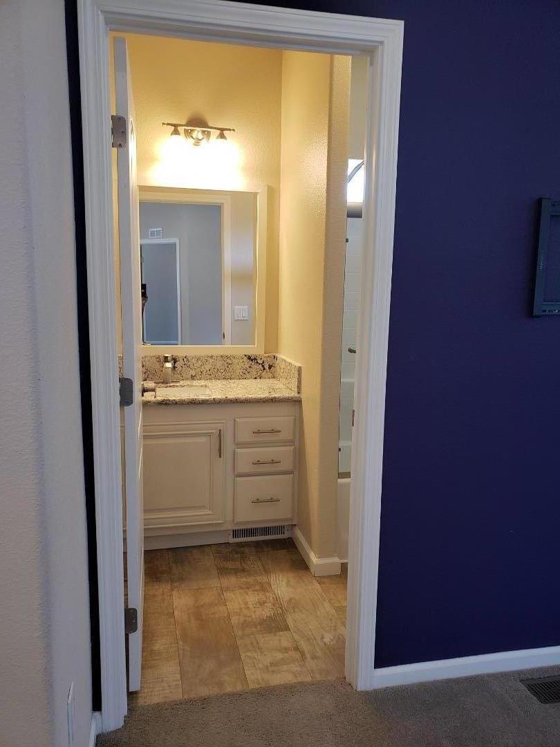 440 Moffett Boulevard, Unit 84 Mountain View, CA 94043 - Photo 28 of 38 a bathroom with a granite countertop sink and a mirror
