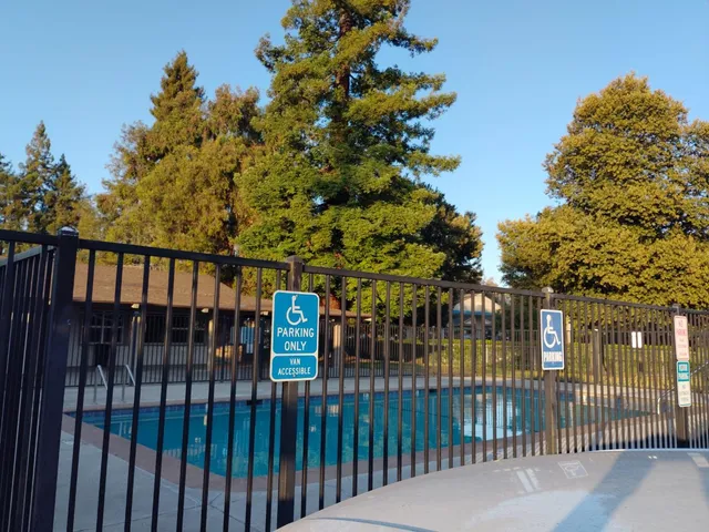 a kitchen with a sink and a stove with living room