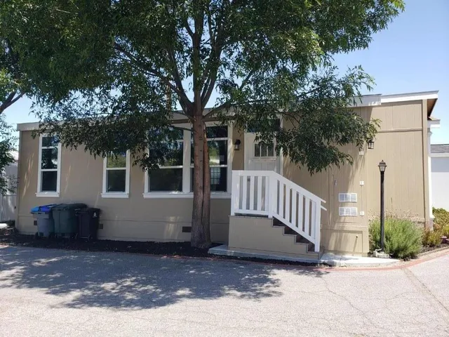 a view of a house with a tree in front