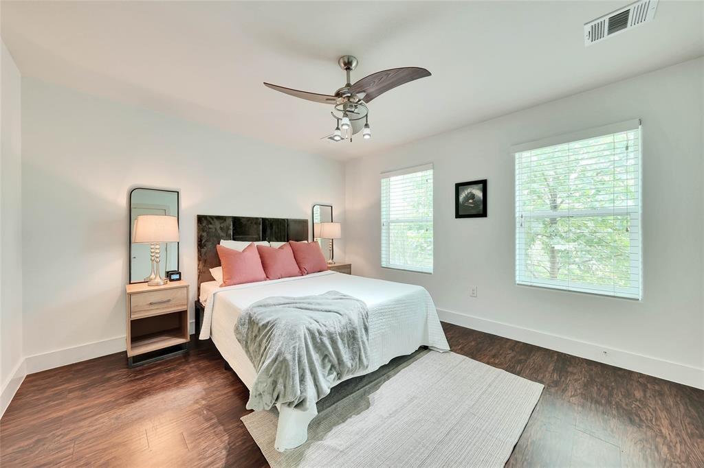 1101 Grove Boulevard, Unit 608 Austin, TX 78741 - Photo 12 of 17 a bedroom with a bed and wooden floor