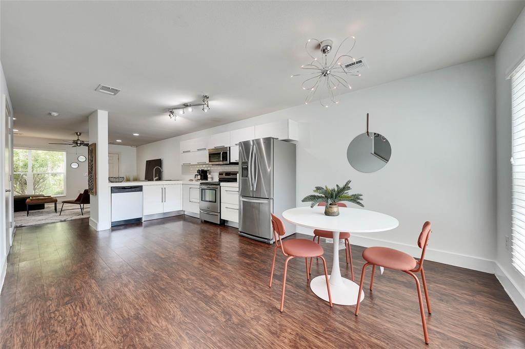 1101 Grove Boulevard, Unit 608 Austin, TX 78741 - Photo 6 of 17 a view of a dining room with furniture and wooden floor