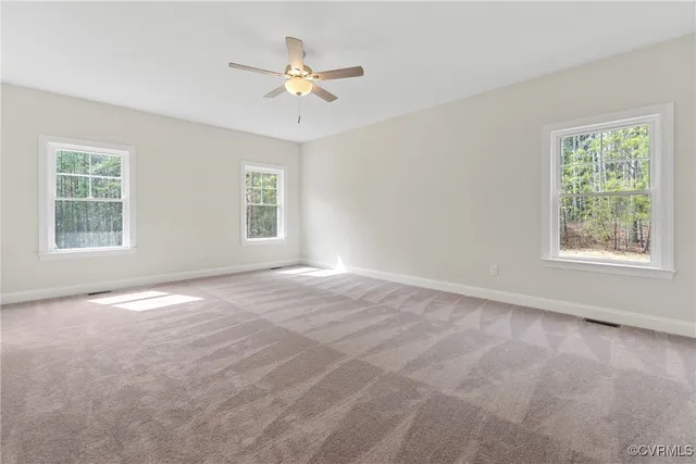 a spacious bedroom with a large bed couch and a window