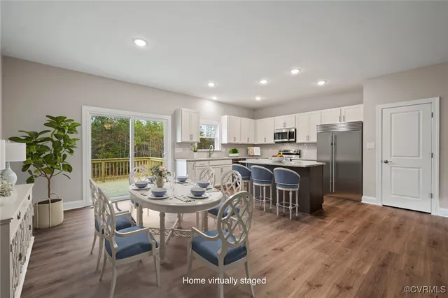 a view of a dining room with furniture and wooden floor