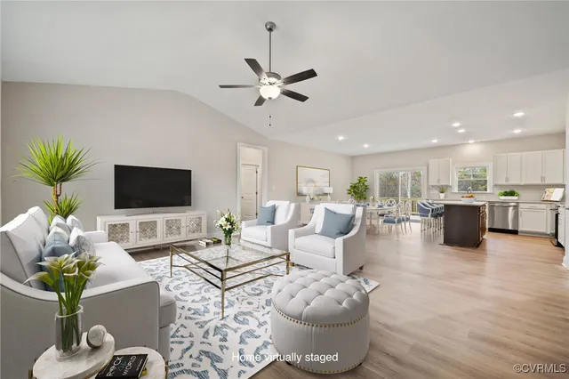 a view of a dining room and livingroom with furniture wooden floor a chandelier