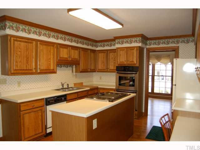 The large kitchen as a built-in chopping block, new double ovens, island w/electric stove & a down draft exhaust fan & plenty of counterspace for the cook in the family. The kitchen has a double door pantry. Plenty of storage in this kitchen! Kitchen
