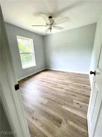 a view of a room with wooden floor and windows