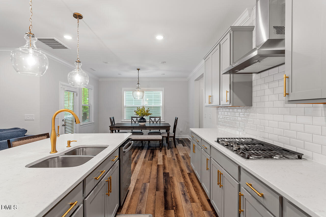 3932 Mount Moran Road Raleigh, NC 27616 - Photo 11 of 40 a kitchen with counter top space a sink stainless steel appliances and cabinets
