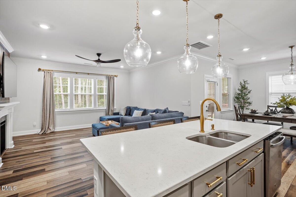 3932 Mount Moran Road Raleigh, NC 27616 - Photo 12 of 40 a kitchen with a sink a stove and chairs