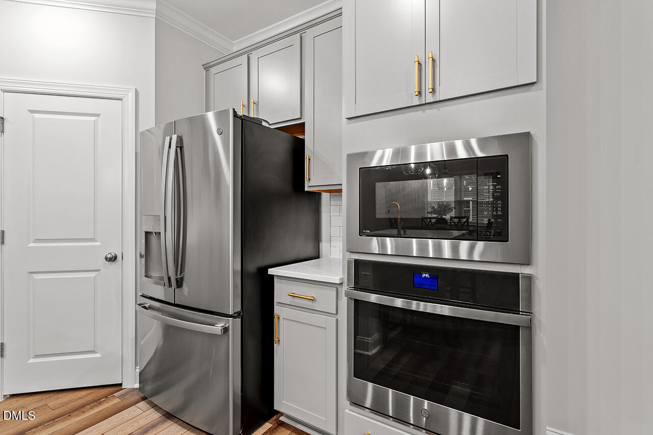 3932 Mount Moran Road Raleigh, NC 27616 - Photo 14 of 40 a kitchen with stainless steel appliances a refrigerator stove and microwave