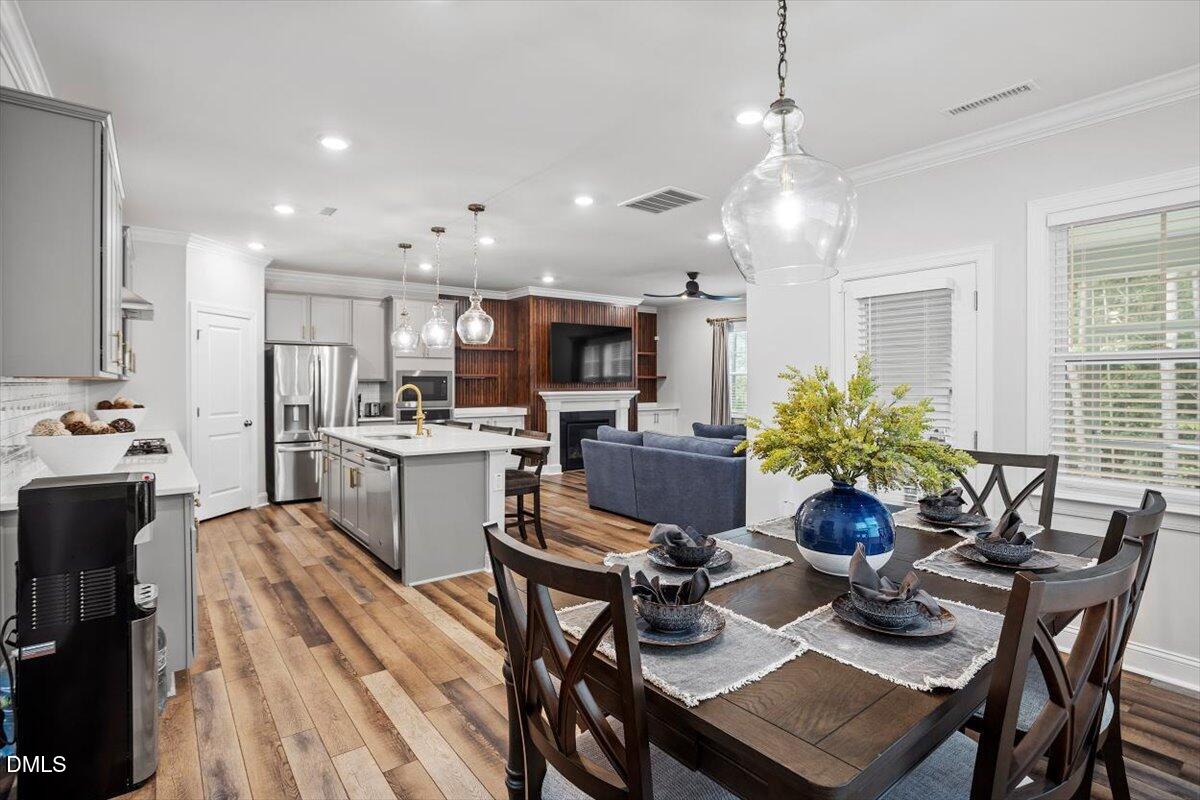 3932 Mount Moran Road Raleigh, NC 27616 - Photo 15 of 40 a kitchen with a dining table chairs stainless steel appliances and cabinets