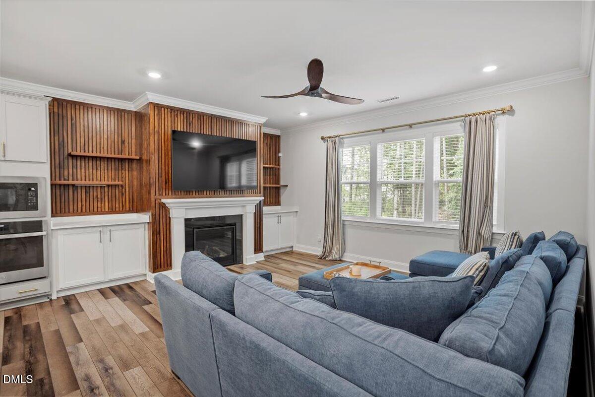 3932 Mount Moran Road Raleigh, NC 27616 - Photo 16 of 40 a living room with furniture a flat screen tv and a fireplace