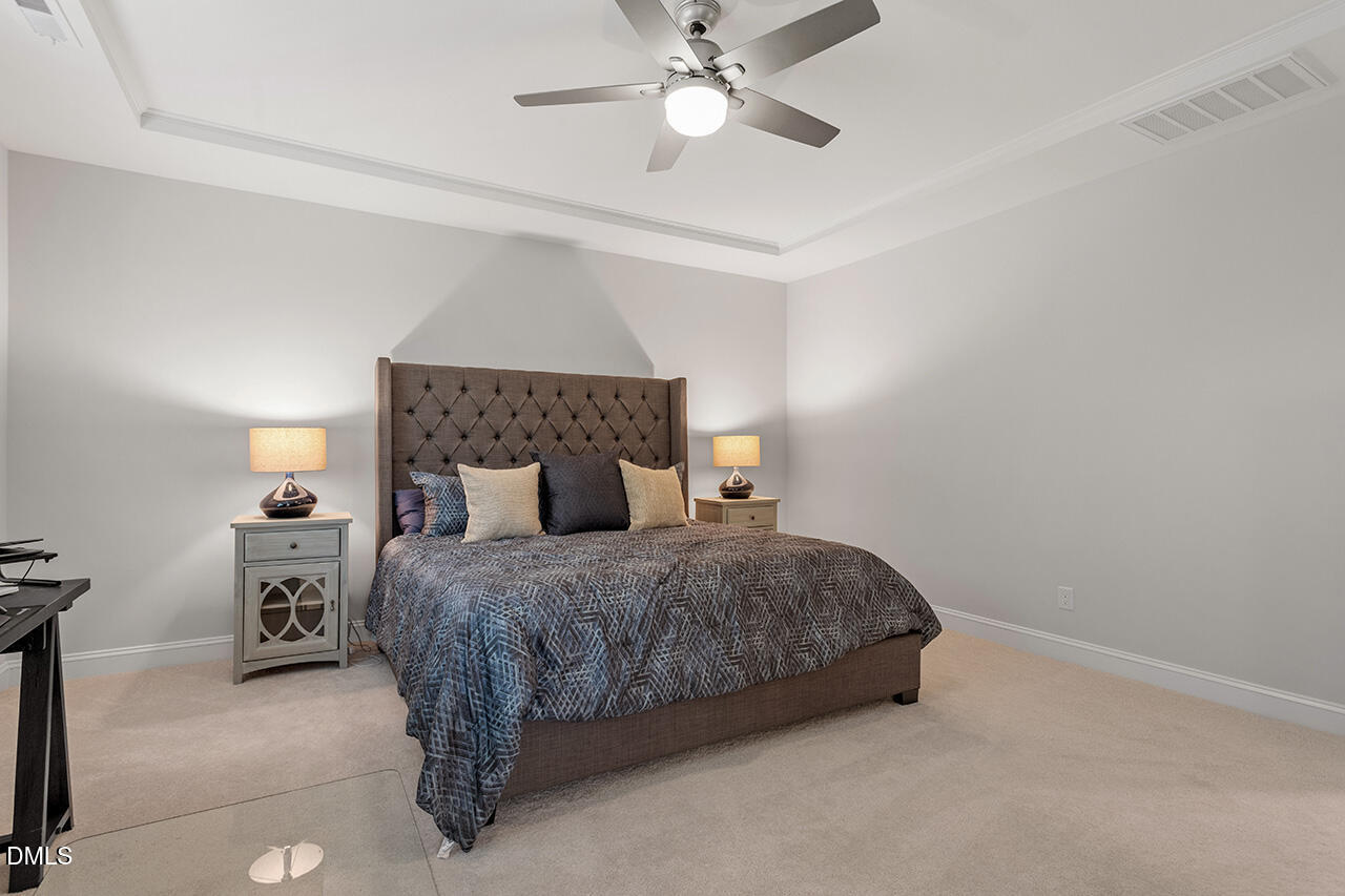 3932 Mount Moran Road Raleigh, NC 27616 - Photo 23 of 40 a bedroom with a bed and a chandelier