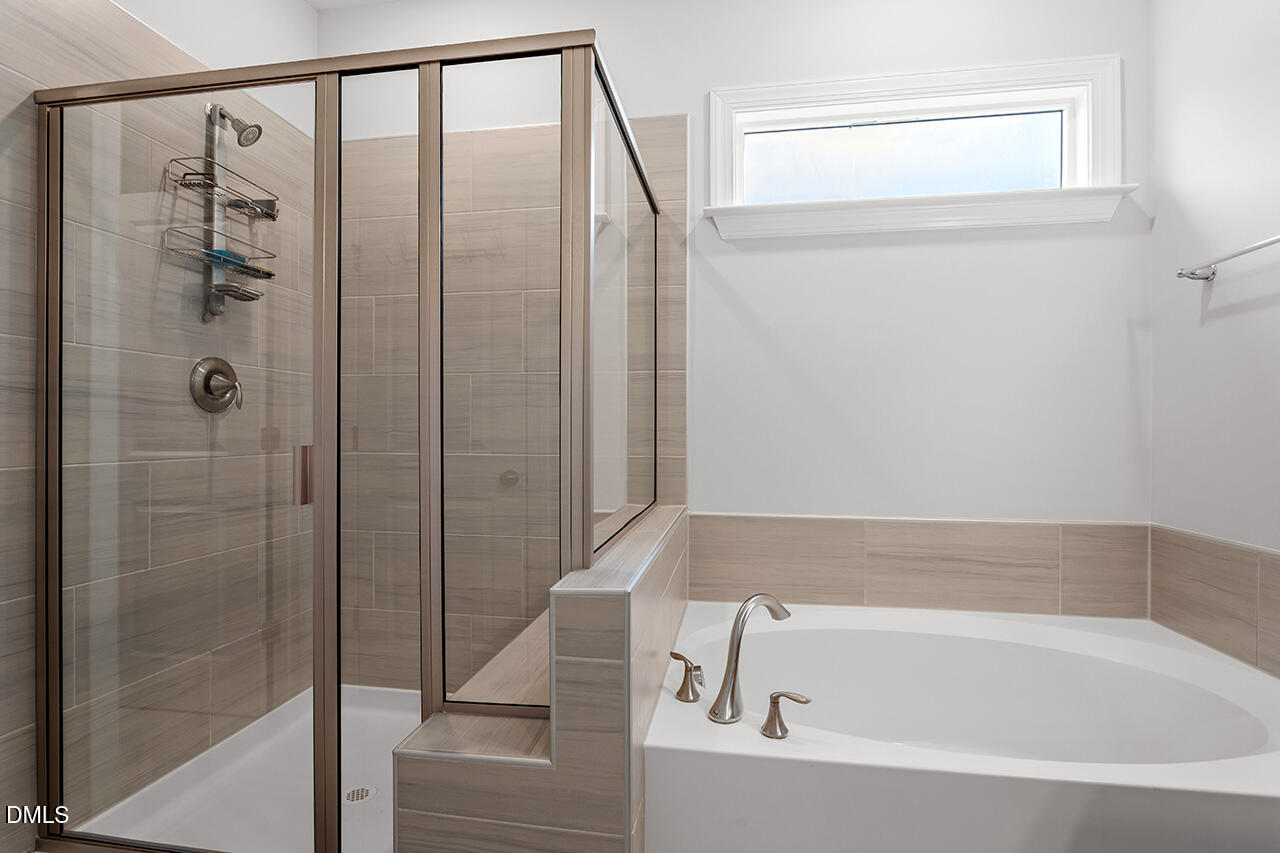 3932 Mount Moran Road Raleigh, NC 27616 - Photo 25 of 40 a bathroom with a bathtub and shower