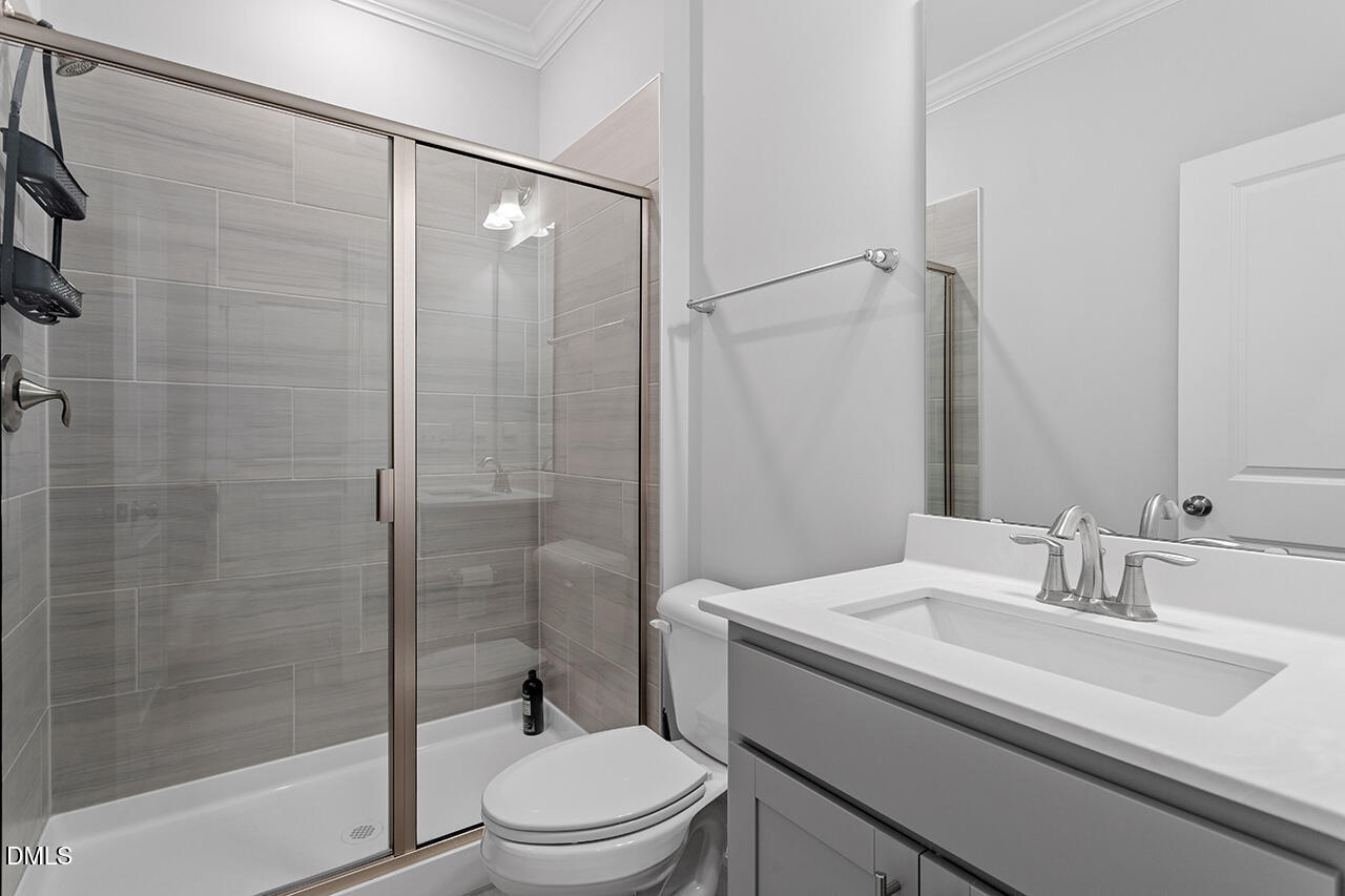 3932 Mount Moran Road Raleigh, NC 27616 - Photo 27 of 40 a bathroom with a sink a toilet and shower