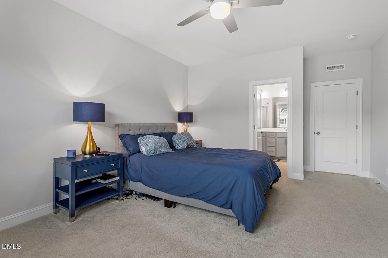3932 Mount Moran Road Raleigh, NC 27616 - Photo 29 of 40 a bedroom with a bed and a chandelier