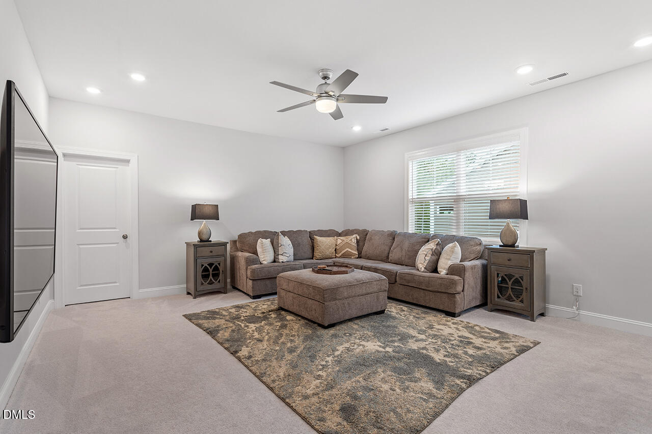 3932 Mount Moran Road Raleigh, NC 27616 - Photo 30 of 40 a living room with furniture a ceiling fan and a rug