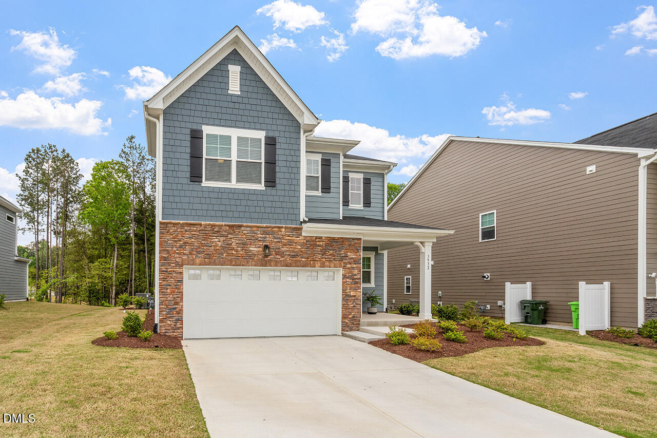 3932 Mount Moran Road Raleigh, NC 27616 - Photo 3 of 40 a front view of a house with a yard and garage