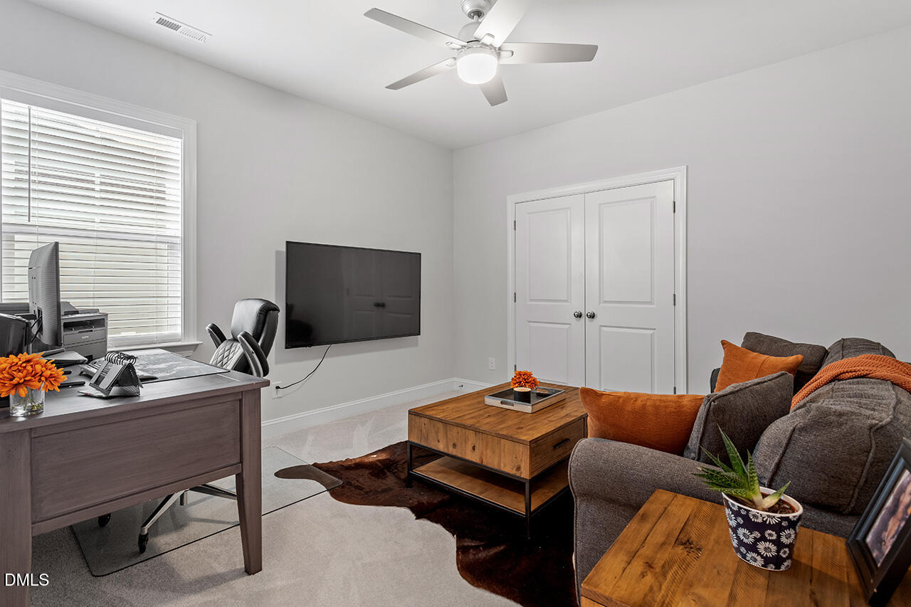 3932 Mount Moran Road Raleigh, NC 27616 - Photo 32 of 40 a living room with furniture and a flat screen tv