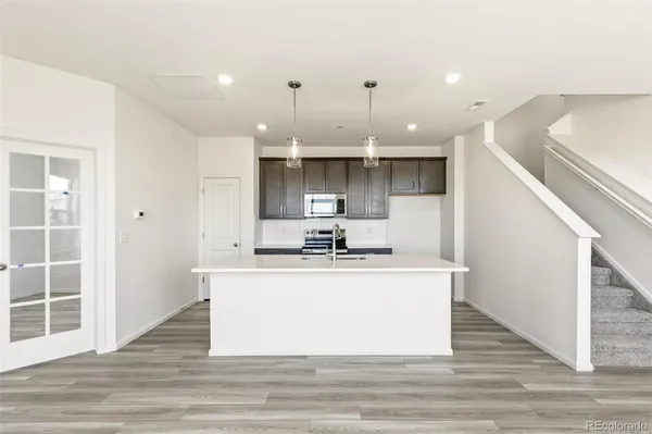 a view of kitchen with stainless steel appliances granite countertop sink stove and cabinets