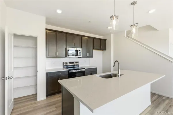 a kitchen with stainless steel appliances a sink and stove