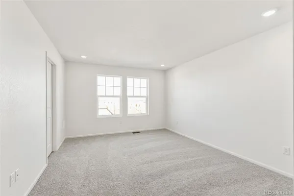 an empty room with a empty space and windows