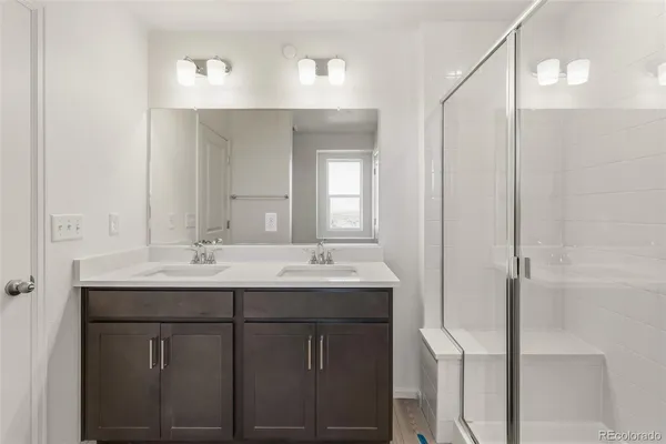 a bathroom with a double vanity sink mirror and double