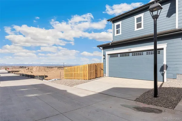 a view of a house with wooden fence