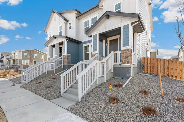 a front view of a house with wooden stairs