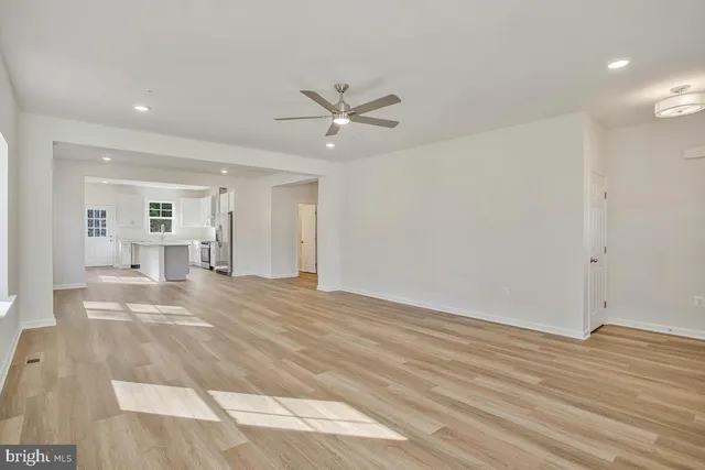 a view of a livingroom with a furniture wooden floor and a ceiling fan