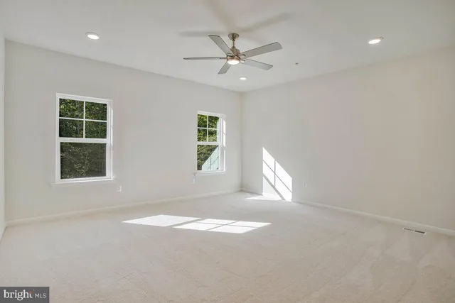 an empty room with windows and closet