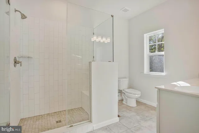 a bathroom with a toilet sink and shower
