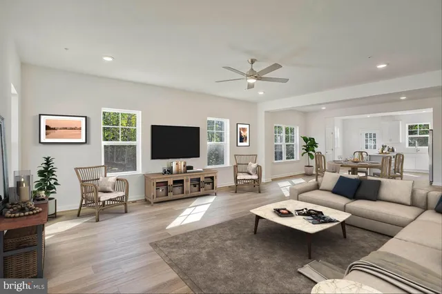 a living room with furniture flat screen tv and wooden floor
