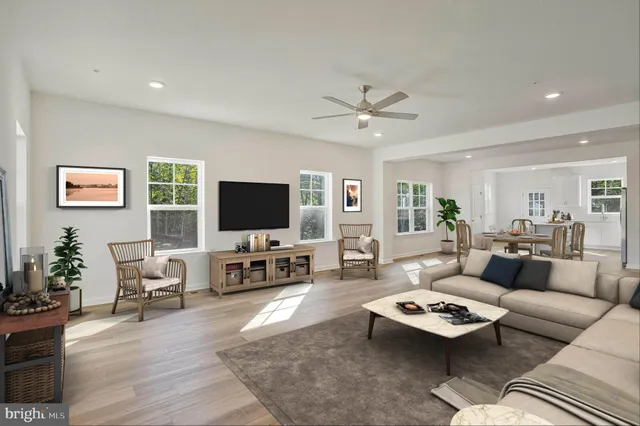 a living room with furniture flat screen tv and wooden floor