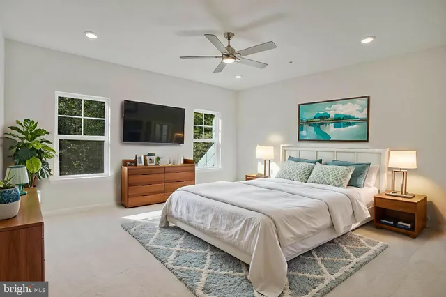 a spacious bedroom with a bed and a flat screen television