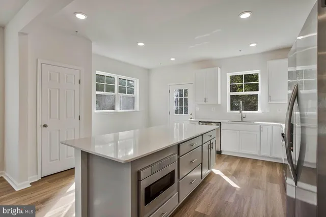 a kitchen with a sink stove and refrigerator
